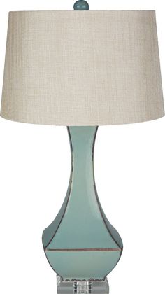 a blue lamp with a beige shade on it