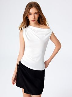 a woman in a white top and black skirt Versatile Solid Sleeveless Blouse, Solid Color Stretch Tank Blouse, Versatile Stretch Vest Tops, Elegant Fitted Sleeveless Top, White Fitted Sleeveless Top, Elegant Stretch Vest Tops, Elegant Sleeveless Stretch Tops, White Fitted Sleeveless Blouse, Versatile Sleeveless Vest Top