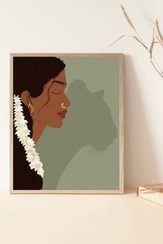 a framed photo of a woman's face with flowers in her hair