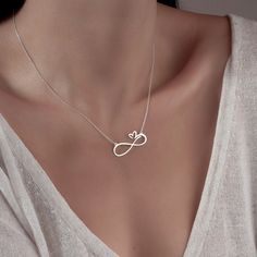 Elevate your style with the timeless elegance of the Sussex Home Heart Infinity Necklace. This exquisite piece symbolizes eternal love, crafted meticulously by hand from sterling silver, ensuring each necklace is unique and of the highest quality. Perfect for bridesmaids, friends, or a special treat for yourself, this necklace adds a touch of sophistication to any outfit.

- Material: Sterling Silver
- Color: Silver
- Gender: Female
- Age Group: Adult

To maintain the necklace's luster, avoid di Serotonin Necklace, Treble Clef Necklace, Infinity Necklace Silver, Silver Necklaces Women, Infinity Heart, Gold Statement Necklace, Infinity Necklace, Multi Strand Necklace, Eternal Love