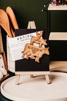 a recipe board with wooden animals on it