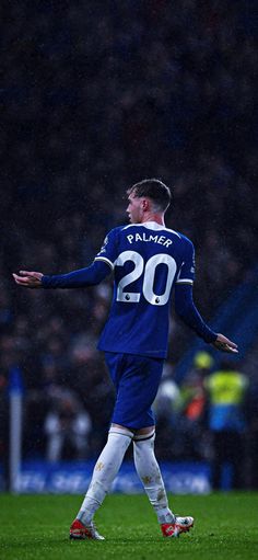 a soccer player with his arms out on the field