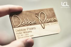 a person holding up a business card that says delibeo pisaro on it