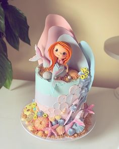 there is a cake decorated with an image of a little mermaid on top of it