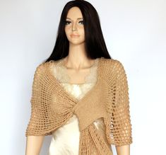 a mannequin wearing a crochet shawl and dress