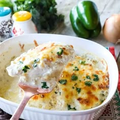 a white bowl filled with chicken and cheese