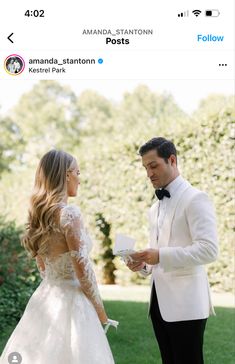 a man in a tuxedo is holding a flower and standing next to a woman in a wedding dress