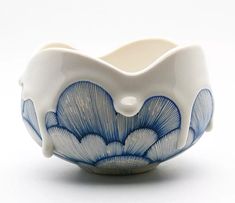 a blue and white bowl sitting on top of a table