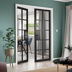 a living room filled with furniture and a glass door leading to a dining room area