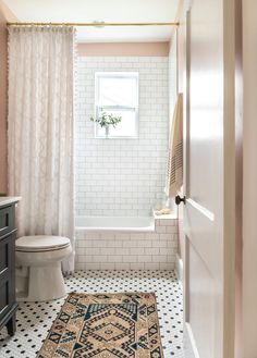 a bathroom with a rug on the floor