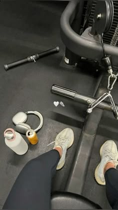 a person is sitting on a treadmill with their feet propped up