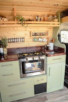 a kitchen area with an oven, stove and sink in it's center wall