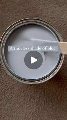 a paint can with a wooden stick in it and the words, a timeless shade of blue