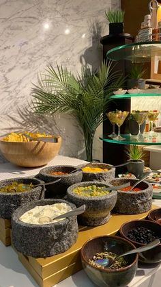 a table with bowls and plates of food on it