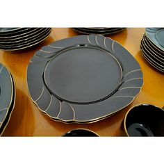 a table topped with lots of black and gold plates