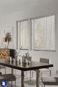 a dining room table and chairs with blinds on the windows behind them, in front of a fireplace