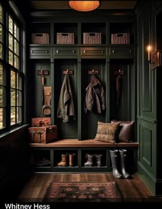 an entryway with green painted walls and wooden flooring, filled with coat racks