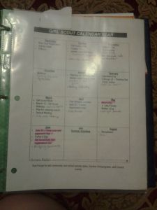 a binder that is open to show the contents of a workbook, with notes on it