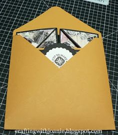 an open envelope with some pictures in the pocket and a piece of paper sticking out of it