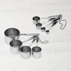 several pots and pans on a white table