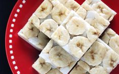 sliced bananas are arranged on top of marshmallows in a red plate with white polka dots