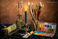 an assortment of art supplies sitting on top of a table