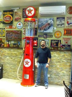 a man standing in front of a red machine