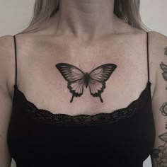 a woman with a butterfly tattoo on her chest