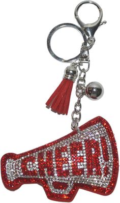 a coca cola bottle shaped keychain with a tassel