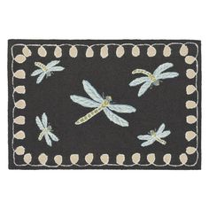 a black door mat with dragonflies on it