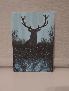 a painting of a deer sitting in the grass