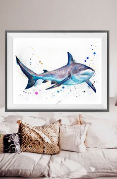 a watercolor painting of a shark on a white wall above a bed with pillows