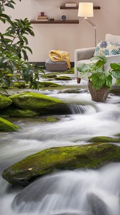 a living room with mossy rocks and water flowing down it's flooring