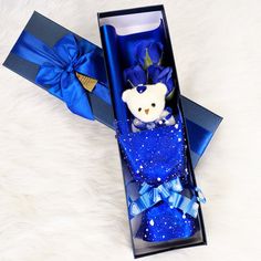 a teddy bear in a blue gift box