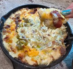 a person is dipping some food into a skillet