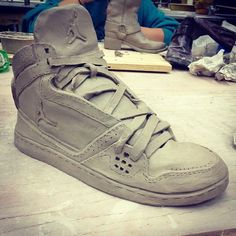 a pair of shoes sitting on top of a wooden table