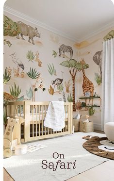 a baby's room with animals and plants painted on the walls, including a crib