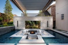 an outdoor living area with couches and fire pit