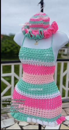 a crocheted dress and hat is displayed on a mannequin