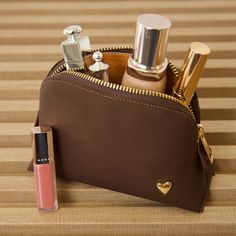 Our cosmetic bag is perfect for carrying your makeup and skincare organized. They are designed to fit perfectly in your purse or your travel bag! Features El portacosméticos no incluye los productos de la imagen. Genuine Leather Signature Heart Interior pocket Designed to stand in their own 4.5" H, 6.5" W, 2" D Compact Bag With Zipper Pocket For Daily Use, Cosmetic And Toiletry Storage Pouch With Zipper, Compact Daily Use Bag With Zipper Pocket, Compact Cosmetic Bag With Removable Pouch For Personal Use, Portable Pouch Cosmetic Bag For Personal Use, Portable Cosmetic Pouch For Personal Use, Portable Cosmetic Bag Pouch, Compact Cosmetic Bag With Zipper For Daily Use, Gift Cosmetic And Toiletry Zipper Pouch