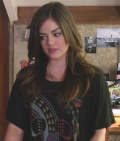 a young woman standing in front of a table