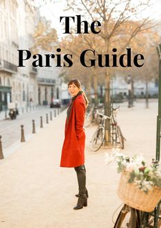 a woman standing in front of a bike with the words the paris guide on it