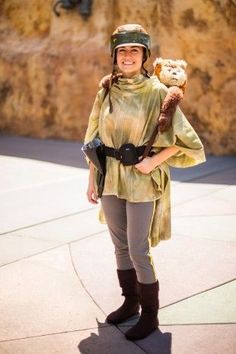 a woman wearing a helmet and holding a teddy bear