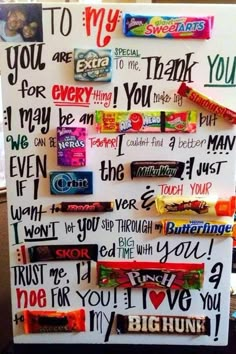 a white board with many different words on it and candy bar wrappers attached to it