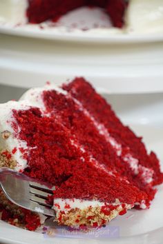 a slice of red velvet cake with white frosting