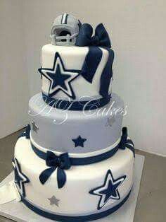 a three tiered cake decorated with stars and a football helmet