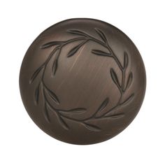 an image of a round door knob with leaves on the front and back side, in antique bronze