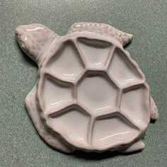 a ceramic turtle shaped dish sitting on top of a counter