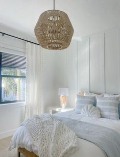 a bedroom with white walls and blue accents