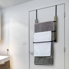 two towels hanging on a towel rack in a bathroom